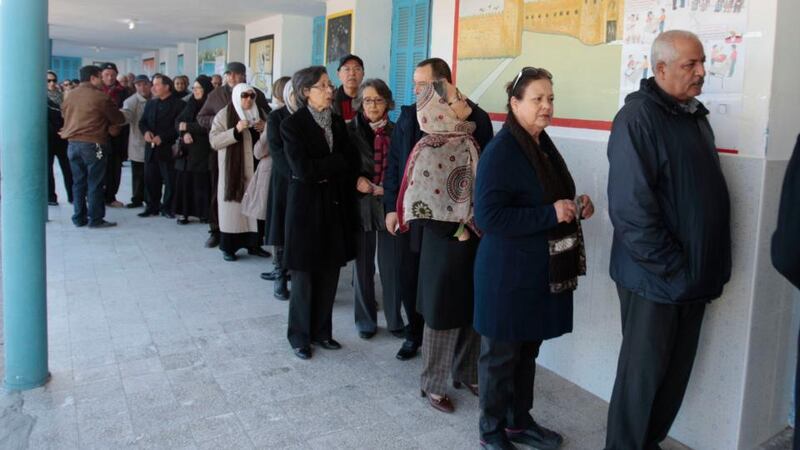 People wait in line outside a polling station to vote in Sousse on Sunday. Tunisians are voting in a presidential run-off election that completes the country’s last steps to full democracy. Photograph: Reuters