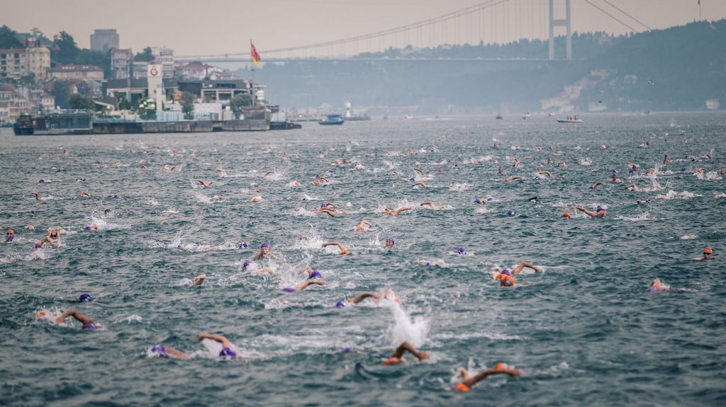 The Bosphorus Cross-Continental Swim. On the day, a flotilla of swimmers is ferried upstream to the east bank, from where they dive off en masse. The race is on!