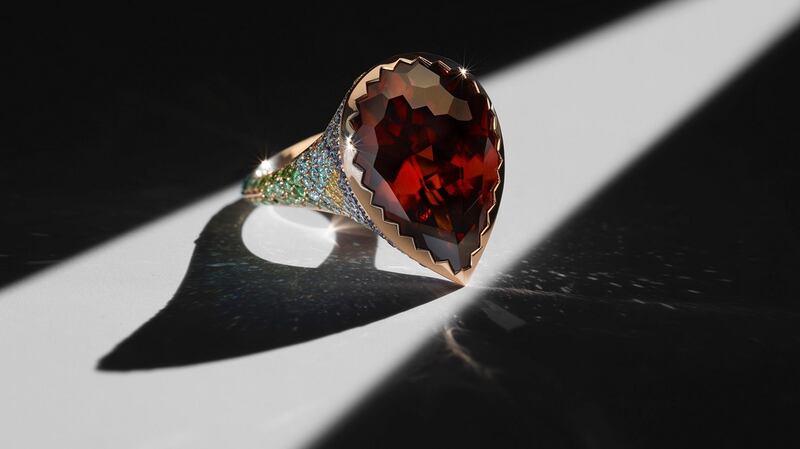 Dante’s Zircon - burnt orange zircon with sidestones of sapphire, light blue, yellow and green diamonds.
