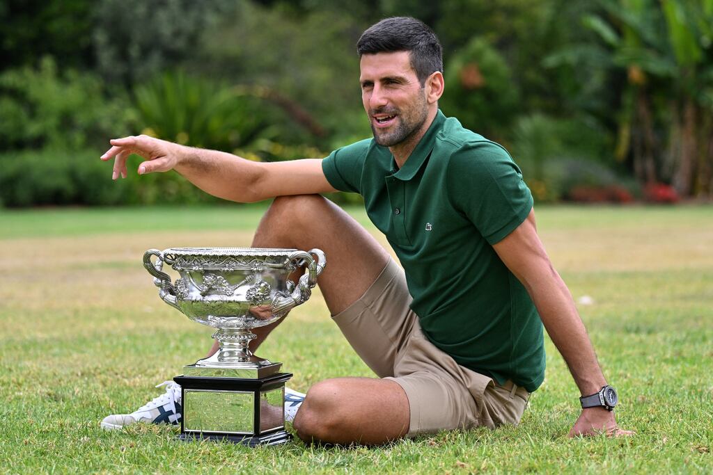 Serbia's Novak Djokovic celebrates with the Norman Brookes Challenge Cup trophy. Photograph: Saeed Khan/AFP via Getty
