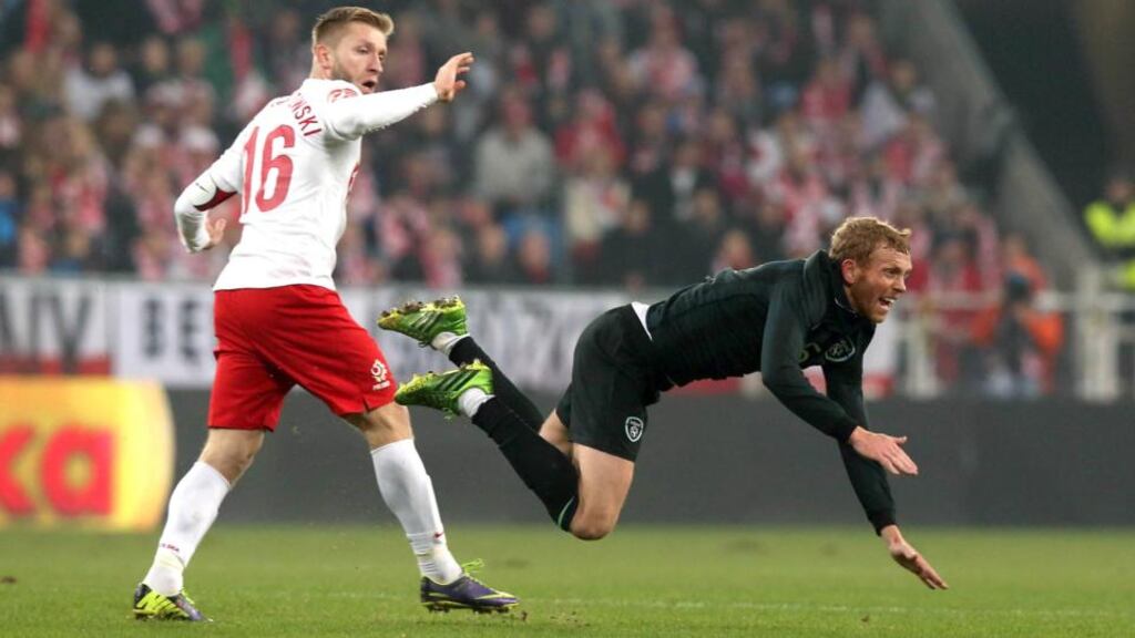 Ireland’s Paul Green (right) and Jakub Blaszczykowski of Poland in Poznan last night. Photograph: Donall Farmer/Inpho