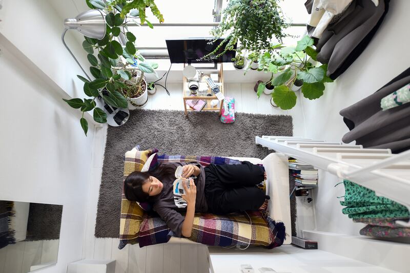 Kana Komatsubara in her apartment known as three-tatami rooms, based on how many standard Japanese floormats can cover the living space. Photograph: Noriko Hayashi/The New York Times
