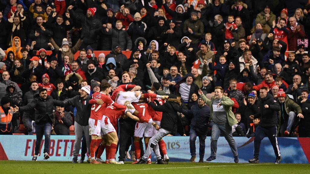 Nottingham Forest fans and players celebrate Lewis Grabban’s late winner against Arsenal. Photograph: Michael Regan/Getty