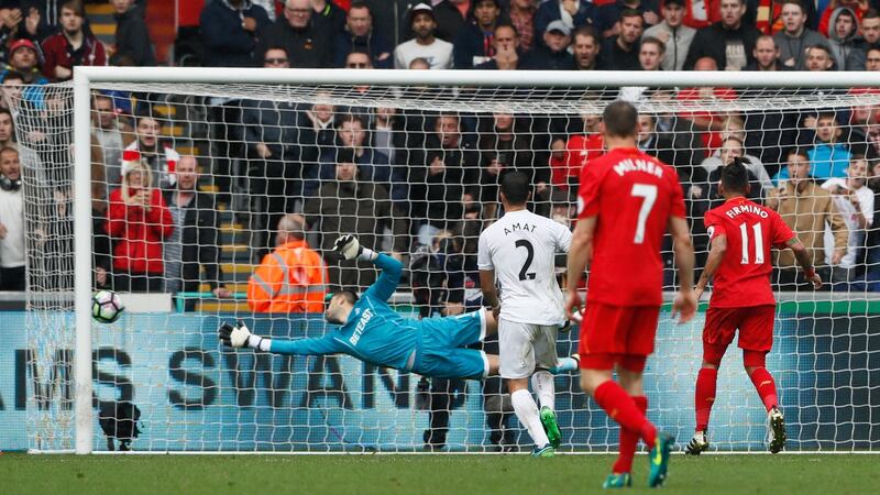 Liverpool’s Roberto Firmino scores against Swansea. Photo: Stefan Wermuth/Reuters