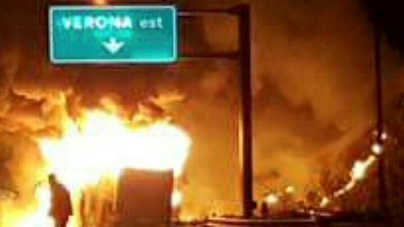 A burning bus, which was carrying Hungarian students, is seen on a side of a motorway, near Verona, northern Italy on Saturday.