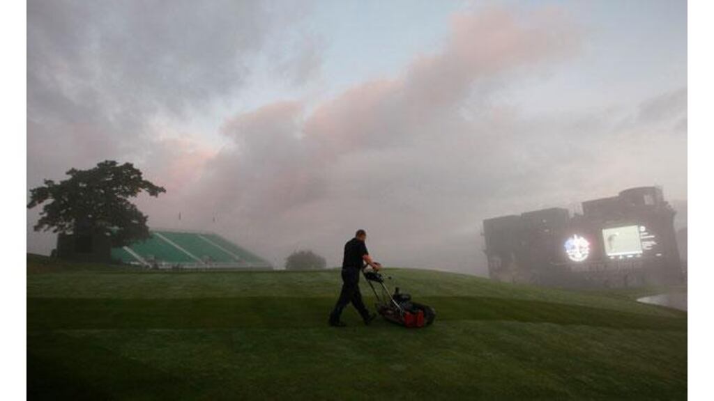 A greenkeeper mows the area around the 18th green at the Celtic Manor this morning ahead of the final practice session before tomorrow’s Ryder Cup. Photograph: Eddie Keogh/Reuters