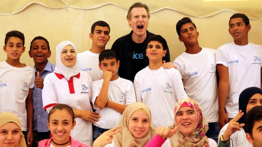 Actor Liam Neeson with Syrian and Jordanian students at a community centre in Amman, Jordan, where he met young Syrian refugees. Photograph: AP Photo/Sam McNeil