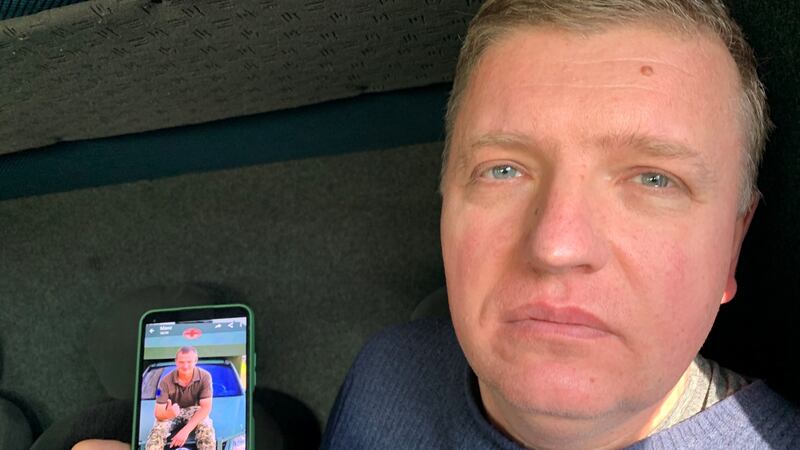 Welder Petro Antonyuk holds up a photograph of his son Maksym, an army medic. Photograph: Lara Marlowe