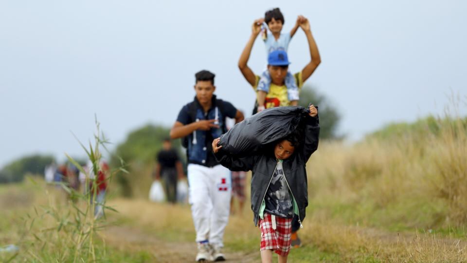 Syrian migrants walk along a road after crossing the Hungarian-Serbian border into Hungary, near Roszke. Photograph: Laszlo Balogh/Reuters