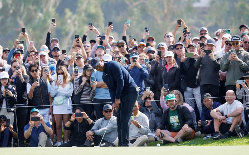 Spectators use their smart phones to capture Tiger Woods putting on the fourth hole during the second round of the Genesis Invitational at Riviera Country Club. Photograph: Gina Ferazzi/Los Angeles Times via Getty Images