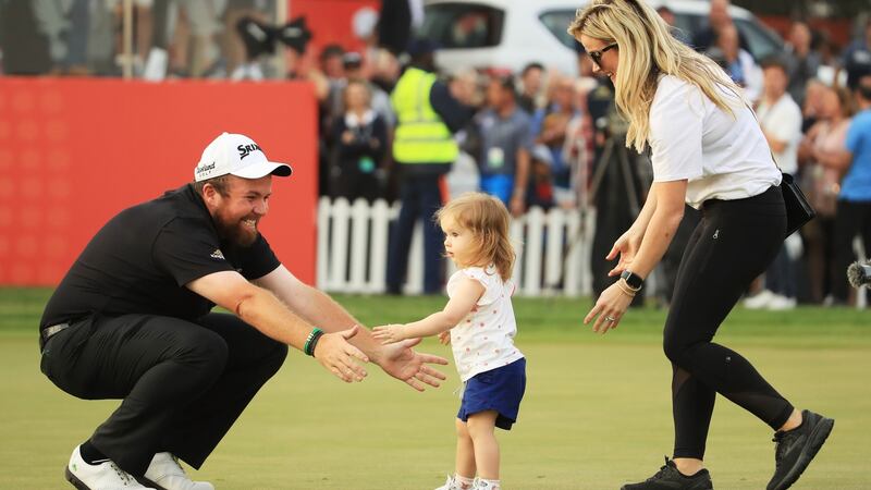 Shane Lowry of Ireland celebrates with wife Wendy and daughter Iris on the 18th green after winning the Abu Dhabi HSBC Golf Championship. Photograph: Andrew Redington/Getty Images