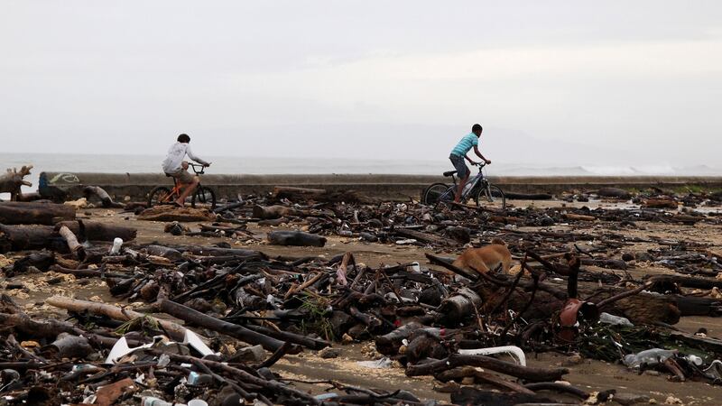 Locals ride their bikes among debris on a beach as Hurricane Irma moves off the northern coast of the Dominican Republic, in Nagua, Dominican Republic, September 7, 2017. Photograph: Reuters/Ricardo Rojas
