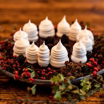 Cheesecake with wild blackberries and meringues inspired by a saucer shape hat made from felted wool and quills