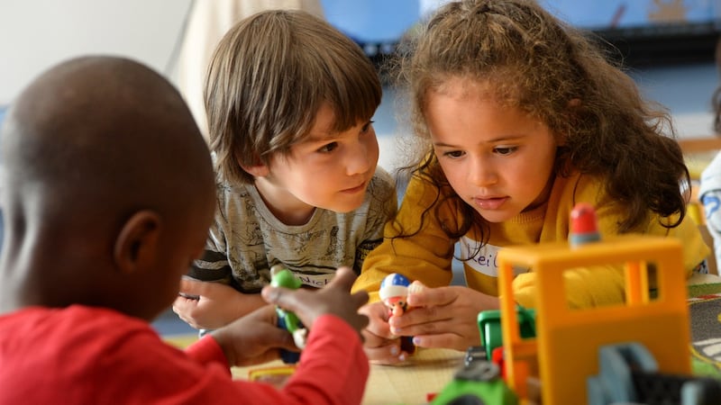 Nicholas Behan and Leila Belabbas with Abdul Samad Sanni, (left) in junior infants on their first day at school in Belmayne Educate Together National School, Belmayne, Dublin 13. Photograph: Dara Mac Dónaill / The Irish Times