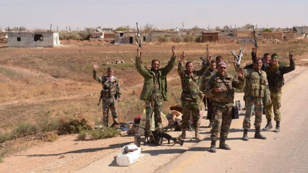 Syrian army soldiers loyal to Syria’s president Bashar al-Assad pose for a photograph with their weapons during what they said was military operation on the road to Khanaser town to clean the roads from mines and improvised explosives in Al-Qabtin in Aleppo province yesterday. Photograph: Reuters