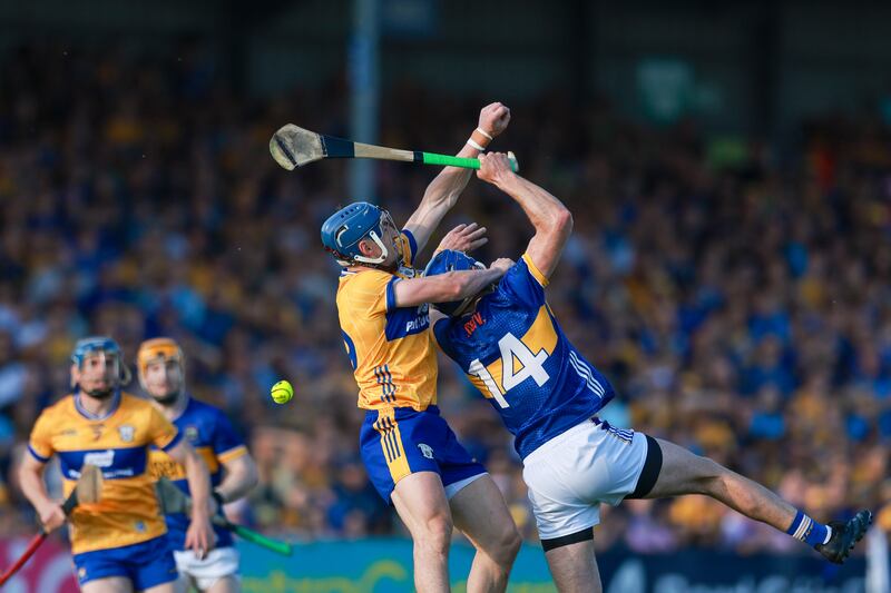 John McGrath of Tipperary competes in the air with Clare's Rory Hayes on Saturday. Photograph: Natasha Barton/Inpho