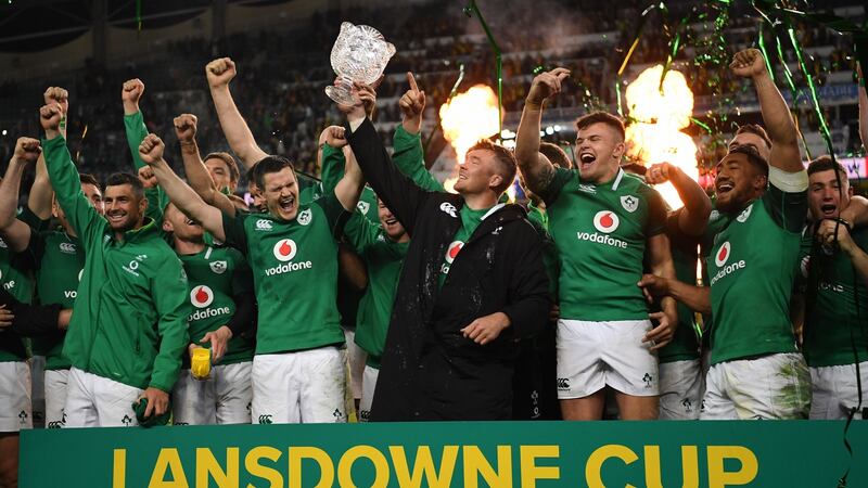 Ireland’s Peter O’Mahony is flanked by his team-mates as holds the winners series trophy after beating Australia in the third Test. Photograph: David Moir/EPA