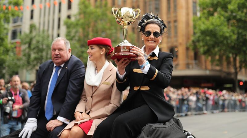 Elliott holds aloft the Melbourne Cup during the parade. Photo: Mark Metcalfe/Getty Images
