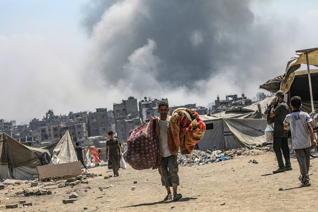 Internally displaced Palestinians flee following an Israeli air strike during a military operation in the east of Al Sheikh Redwan neighbourhood in Gaza City. Photograph: EPA