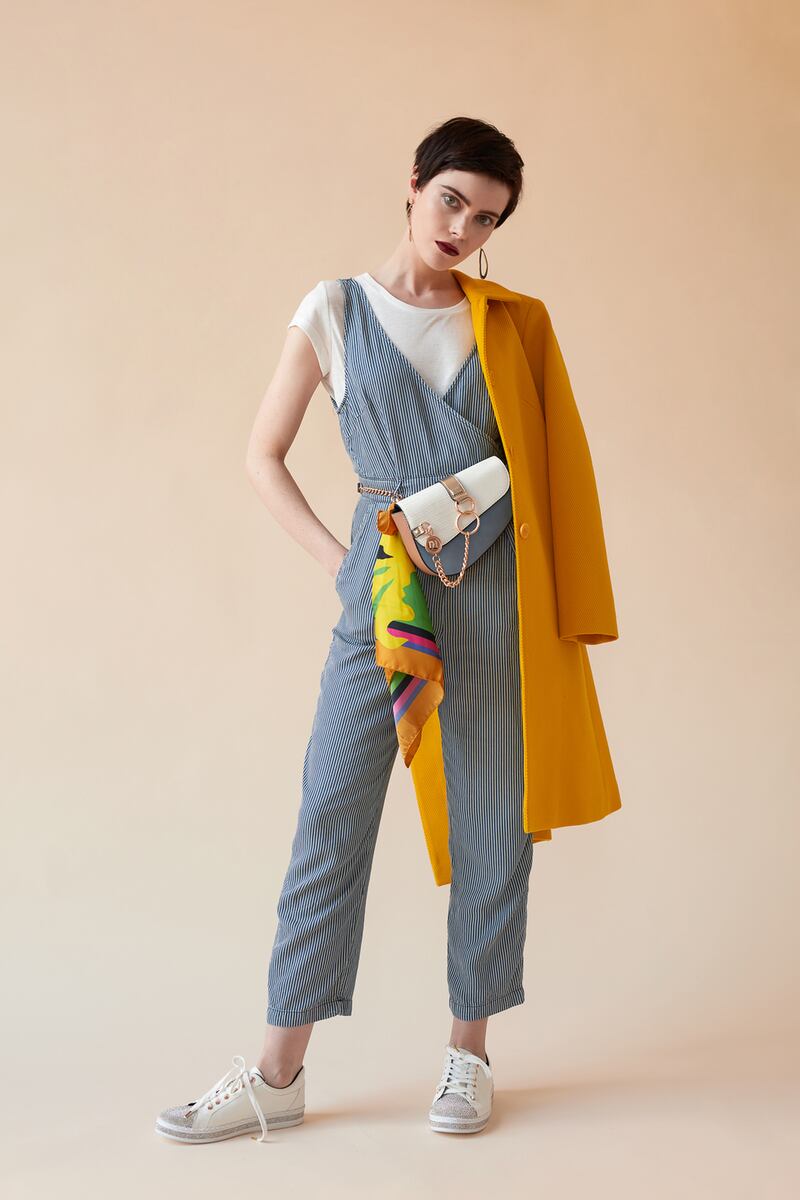 Coat €395 Tara Jarmon, indigo jumpsuit €160, T-shirt €45 French Connection, Arnotts, bag €33, trainers €50 River Island, scarf Ciara Silke.