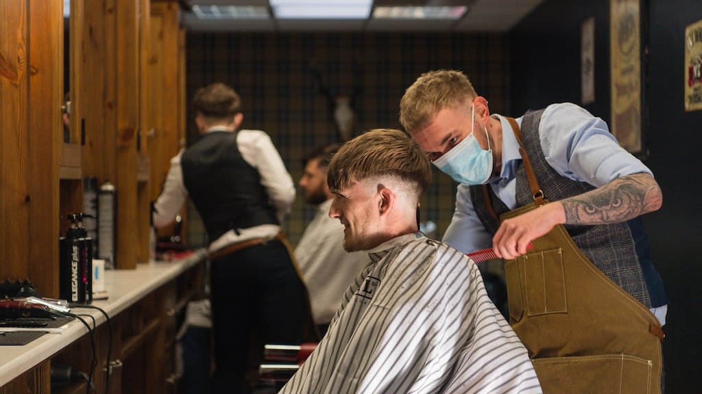 Kyle Doherty gets a trim from Brad Ferguson at Switchblade Barbers, Enniskillen. Photograph: Ronan McGrade