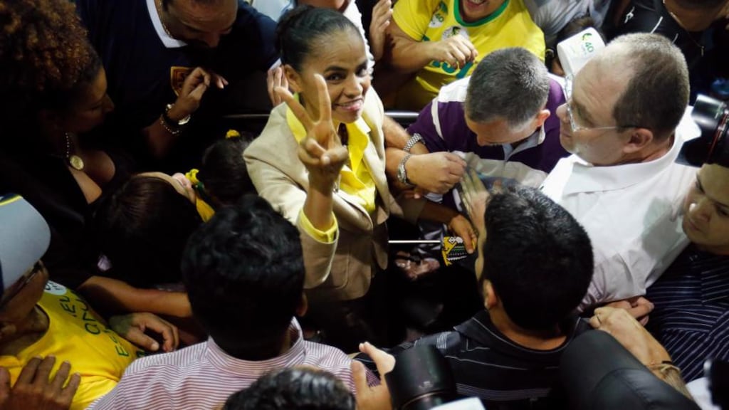 Brazilian socialist presidential candidate Marina Silva (top centre) is mobbed as she arrives at the airport in her hometown of Rio Branco, where she will vote in the general elections today. Photograph: Sergio Moraes/Reuters.