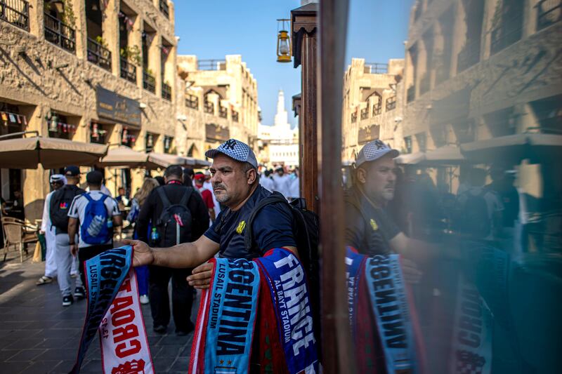 A street vendor in Souq Waqif hopes demand for scarves in the desert will pick up before Sunday's World Cup final. Photograph: Martin Divisek/EPA-EFE