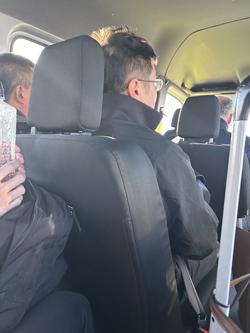Photo taken by Nuria Zyden on a bus in Frankfurt Airport when passengers were being transferred from a flight from Dublin to an onward flight to Sarajevo. Zyden grew suspicious when she saw the two Chinese men who had come on the flight from Dublin were going to Sarajevo where an assembly of the World Uyghur Congress was taking place