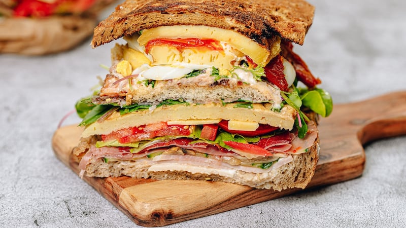 The gargantuan sandwich is arranged in three layers, meat, fish and cheese.