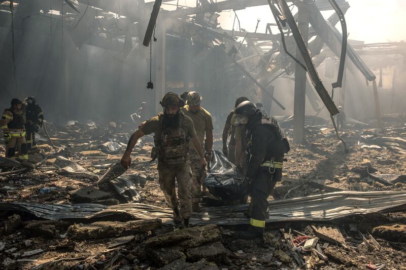 Ukrainian emergency rescue personnel and military members carry a body of a victim who died following a Russian strike on a supermarket following in Kostyantynivka, eastern Donetsk region. Photograph: Roman Pilipey/AFP via Getty Images