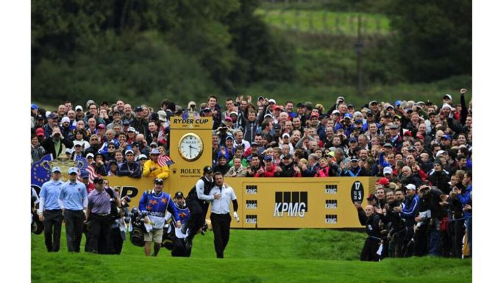 Rory McIlroy can’t hide his jubilation after Graeme McDowell puts his tee shot on 17 close. McIlroy would roll in the birdie putt to seal a 3 and 1 win for the Northern Irish pairing. Photograph: Kieran Doherty/Reuters