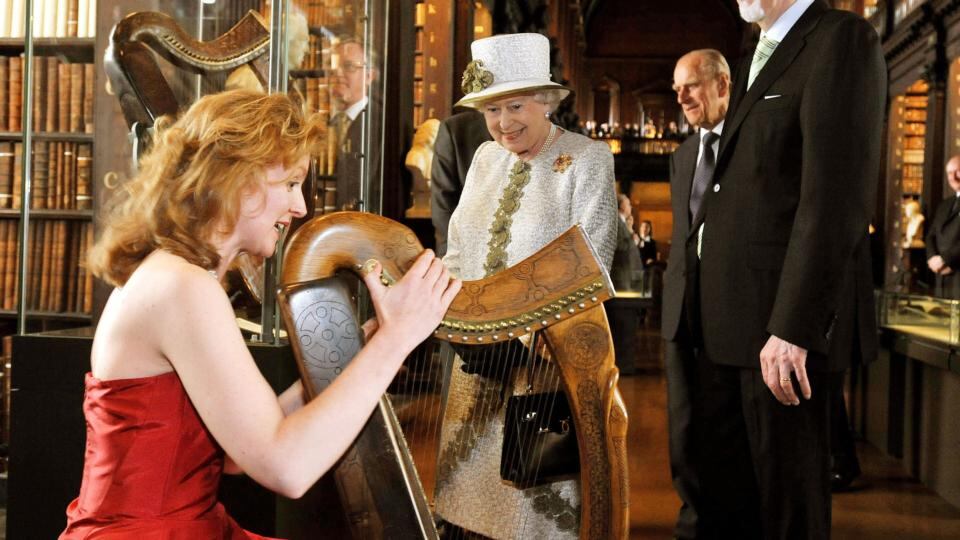 Queen Elizabeth speaks with harpist Siobhan Armstrong beside the Brian Boru   15th-century harp at Trinity College  Dublin in  2011. Photograph: Maxwells