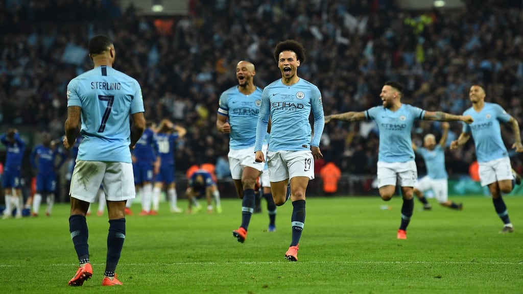 Manchester City’s Leroy Sane leads the charge to celebrate with Raheem Sterling after he scored the winner in the League Cup final win over Chelsea. Photo: Glyn Kirk/Getty Images