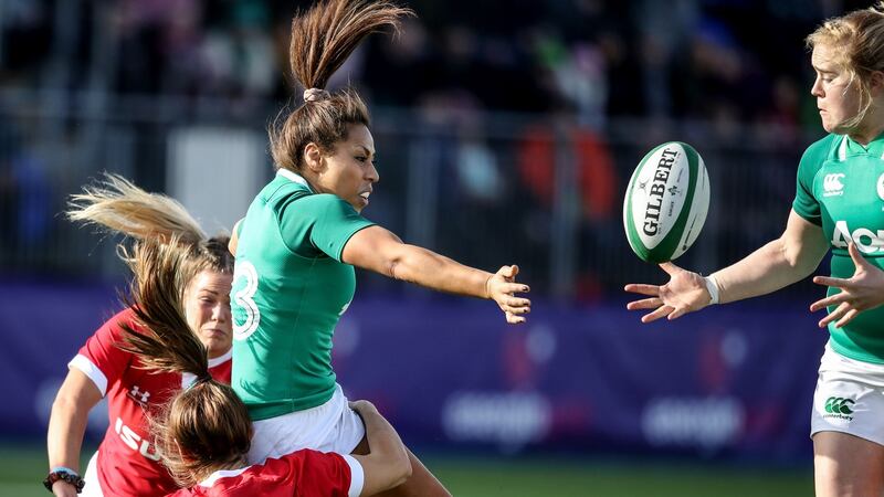 Ireland’s Sene Naoupu offloads to Cliodhna Moloney after being tackled by Kerin Lake and Kelsey Jones of Wales. Photograph: Dan Sheridan/Inpho