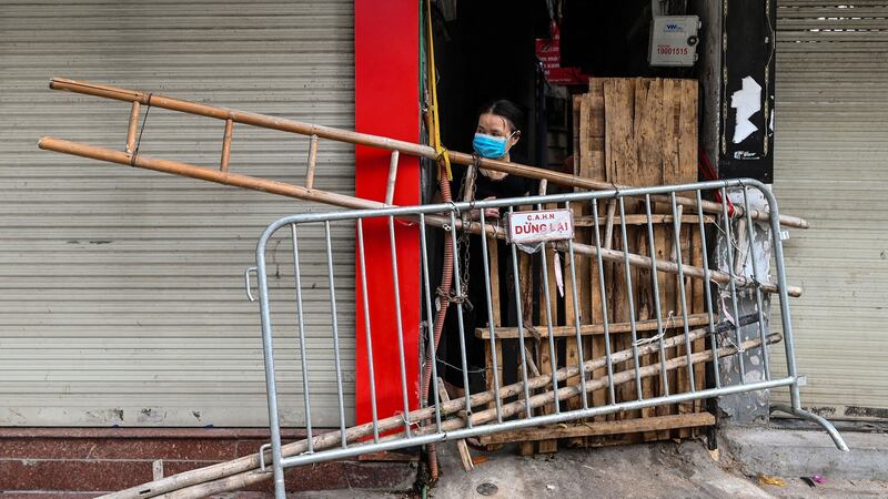 Bamboo poles, beer crates, ladders and broken chairs form make-shift barricades on Hanoi’s streets as authorities try to slow the spread of virus. Photograph: Manan Vatsyayana/AFP via Getty