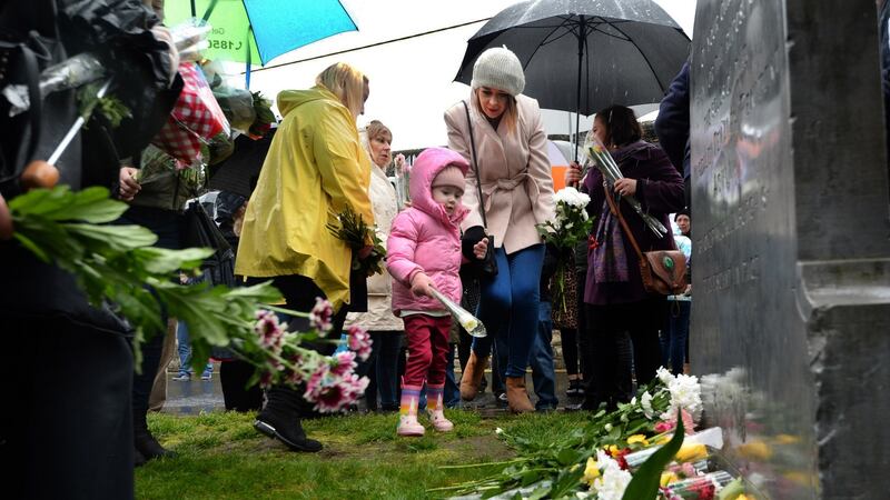 Roisín Keane (4), from Rush, with her aunt Aoife Downes, at Glasnevin Cemetery in Dublin for the eighth annual Flowers for Magdalenes memorial event. Photograph: Dara Mac Dónaill/The Irish Times