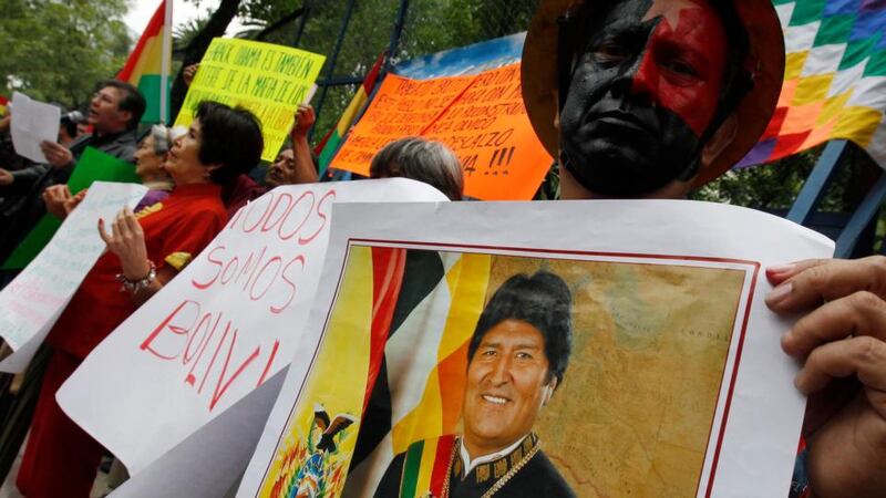 A man holds up a poster with an image of Bolivian president Evo Morales during a protest in support of the Bolivian president in front of the US embassy in Mexico City. Photograph: Henry Romero/Reuters