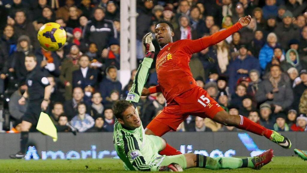 Liverpool’s Daniel Sturridge (right) scores against Fulham despite the efforts of goalkeeper Maarten Stekelenburg during their Premier League match at Craven Cottage. Photograph: Eddie Keogh/Reuters