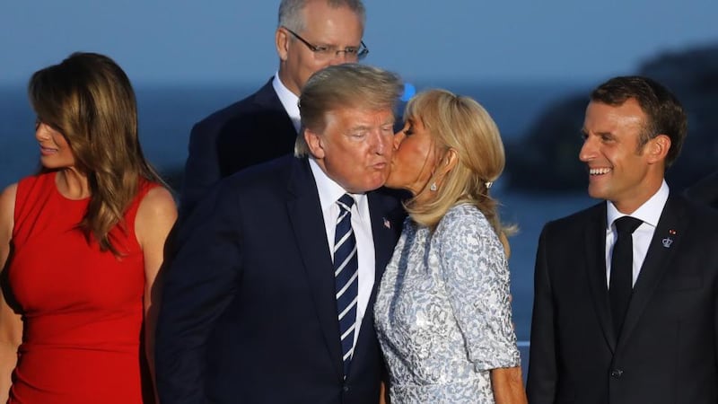 Brigitte Macron, wife of French president Emmanuel Macron, kisses Donald Trump, flanked by Melania Trump and Mr Macron. Photograph: Ludovic Marin/AFP/Getty