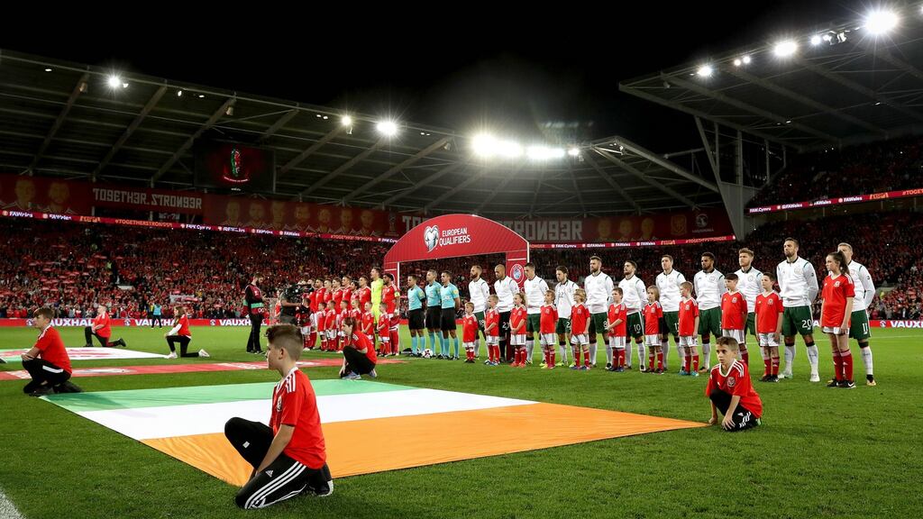 The teams line up for the anthem ahead of the Wales v Republic of Ireland qualifier at Cardiff City Stadium. Photograph: Ryan Byrne/Inpho