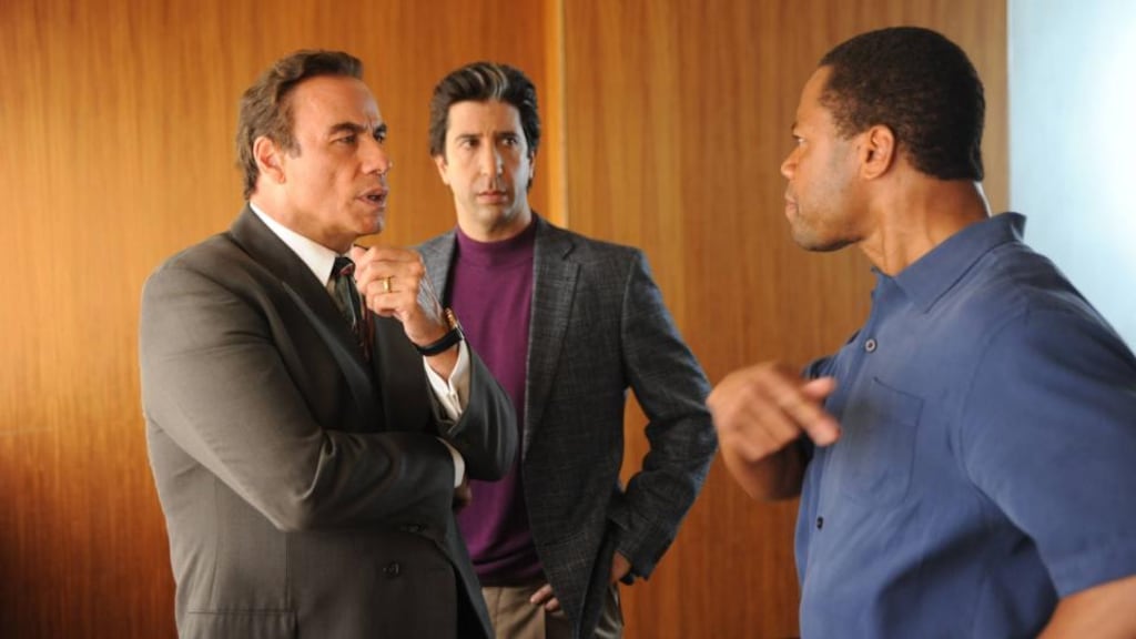 Cuba Gooding Jr as OJ Simpson, with John Travolta and David Schwimmer as defence attorneys Robert Shapiro and Robert Kardashian