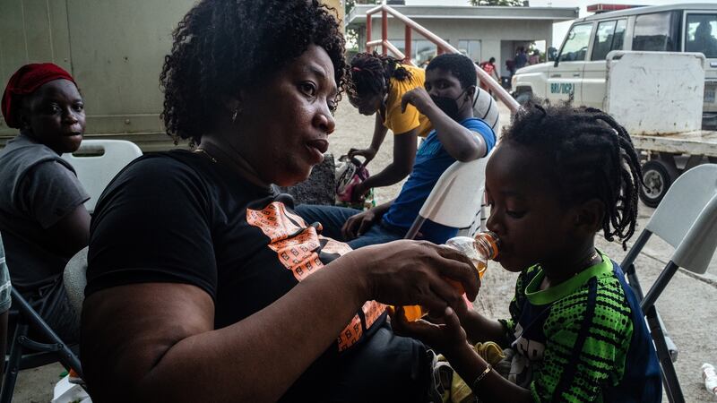 Claire Bazille, who has returned to uncertain prospects in Haiti, and her son after arriving at the airport in Port-au-Prince on Sunday. Photograph: Federico Rios/New York Times