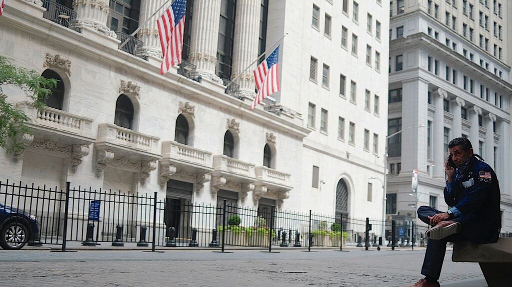 A trader makes a phone call on Wall Street in New York City. File photograph: Johannes Eisele/AFP via Getty Images