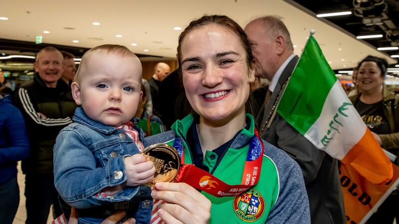 Kellie Harrington shows her gold medal from the Aiba Women’s World Boxing Championships to her 10-month-old cousin Erin Duffy. Photograph: Morgan Treacy/Inpho