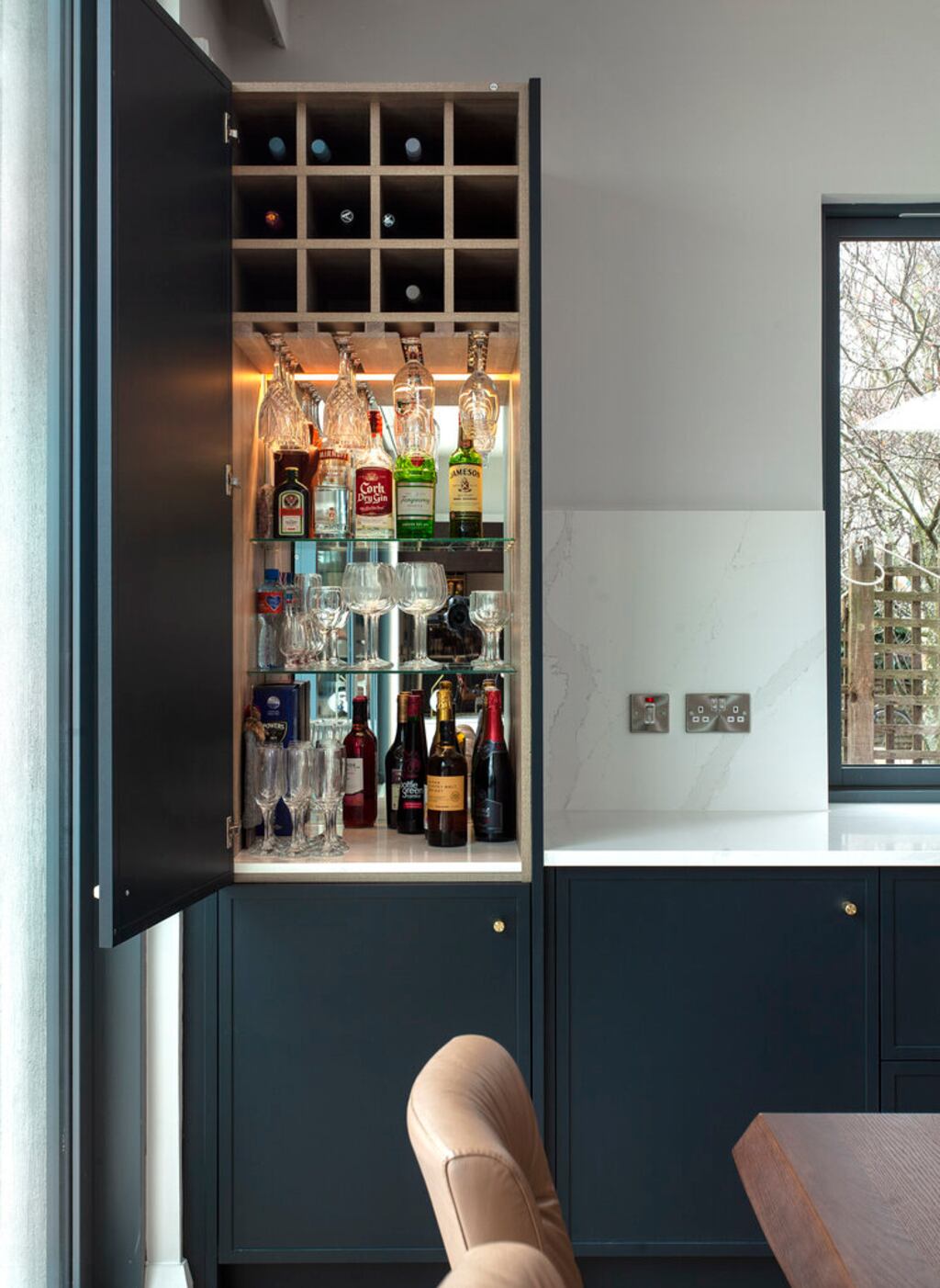 Consider integrating your bar into your kitchen cabinetry for a discreet, space-saving solution. Kitchen by Optimise Design