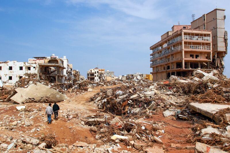 Men walk among the debris of buildings caused by flash floods in Derna, a catastrophe for which Libya, oil-rich but long dysfunctional, was ill-prepared. Photograph: AFP via Getty Images