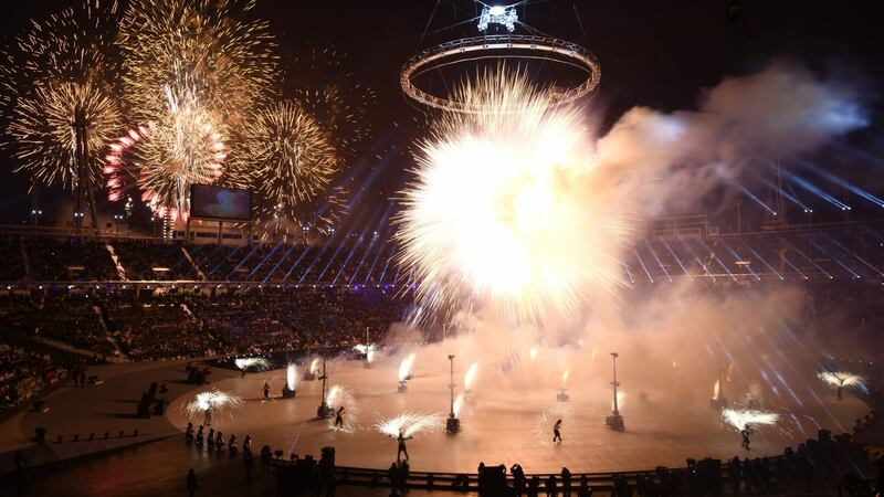 Fireworks go off as the Olympic flame is lit during the opening ceremony. Photo: Jonathan Nackstrand/Getty Images