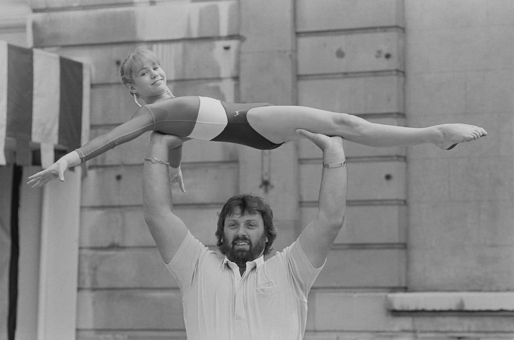 British shot putter, strongman Geoff Capes holding gymnast Amanda Gibbons in 1984. Photograph: B. Gomer/Daily Express/Hulton Archive/Getty