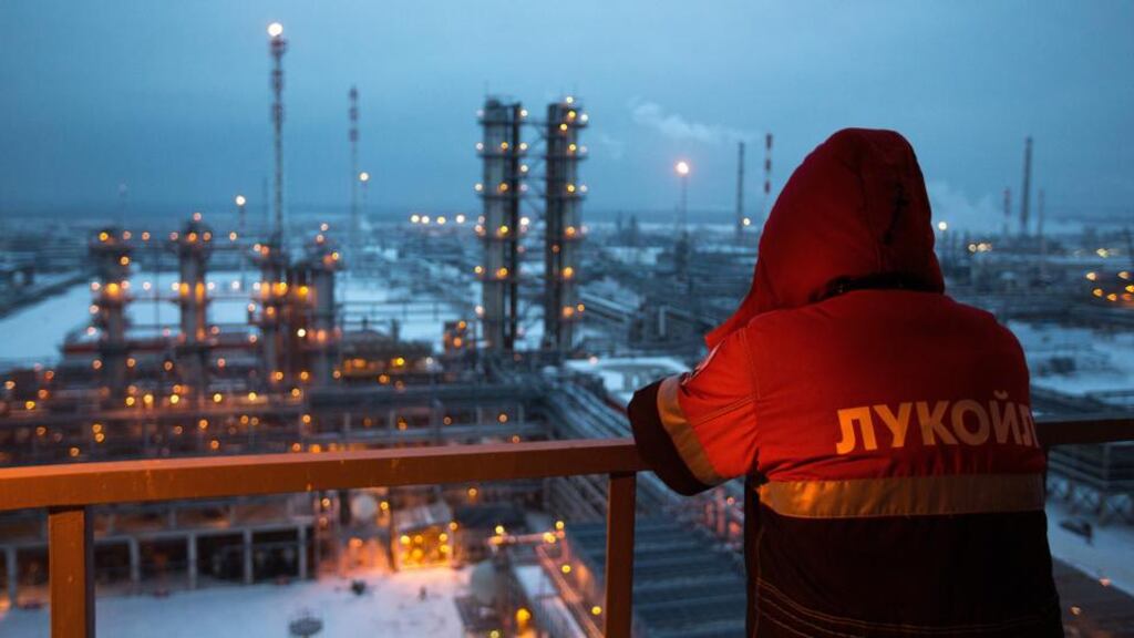 An employee looks out over an oil refinery in Nizhny Novgorod, Russia. The drop in oil prices is driving a sharp recession in the country. Photograph: Andrey Rudakov/Bloomberg