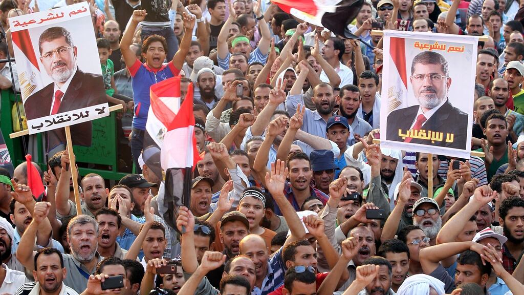 Supporters of the Muslim Brotherhood attend a protest in support of the ousted Egyptian president Mohamed Morsi outside the Rabaa al-Adawiya mosque, in Cairo in August 2013. Photograph: Khaled Elfiqi/EPA